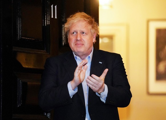 epa08339744 A handout photo made available by No. 10 Downing Street of Britain&#039;s Prime Minister Boris Johnson applauding during a &#039;Claps for our Carers&#039; outside 11 Downing Street in Lon ...