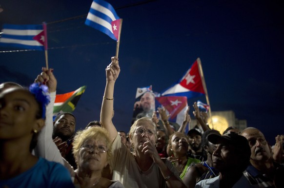 Participants hold portraits of Fidel Castro and Cuban flags during a rally honoring the deceased Cuban leader Fidel Catsro at the Revolution Plaza in Havana, Cuba, Tuesday, Nov. 29, 2016. Schools and  ...
