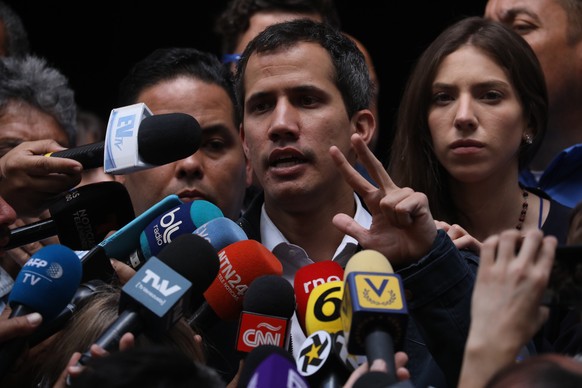 epa07325903 The President of the National Assembly (Parliament) of Venezuela and self-proclaimed interim President of the country Juan Guaido (C), speaks to media after a mass, in the San Jose de Chac ...
