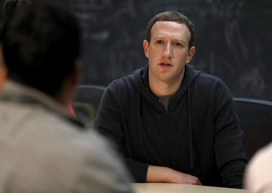 File-This Nov. 9, 2017, file photo shows Facebook CEO Mark Zuckerberg meeting with a group of entrepreneurs and innovators during a round-table discussion at Cortex Innovation Community technology hub ...