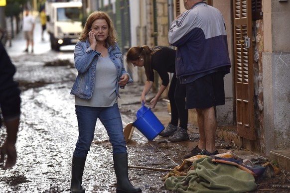 epa07082533 Several residents bail water out their homes in the village of Sant Llorenc, in Mallorca island, eastern Spain, 10 October 2018, a day after the flash floods caused by heavy rainfall hitti ...