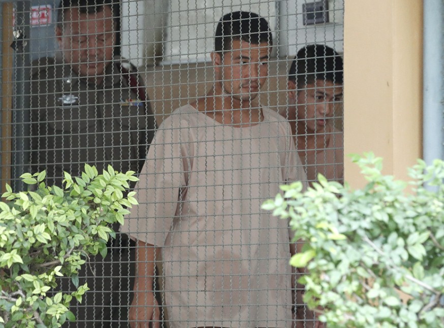 epa07800454 Myanmar murder defendants Zaw Lin (C) and Wai Phyo (R) are escorted by police officers as they arrive for their murder case verdict at a provincial court in Nonthaburi province, Thailand,  ...