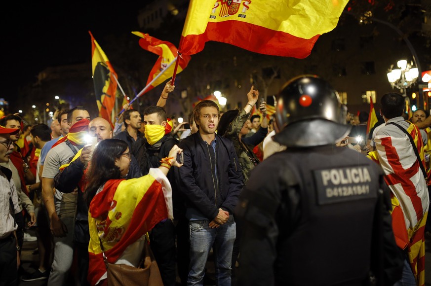 A Catalan riot police stands as anti-independence supporters march against the unilateral declaration of independence approved earlier by the Catalan parliament in downtown Barcelona Friday, Oct. 27,  ...