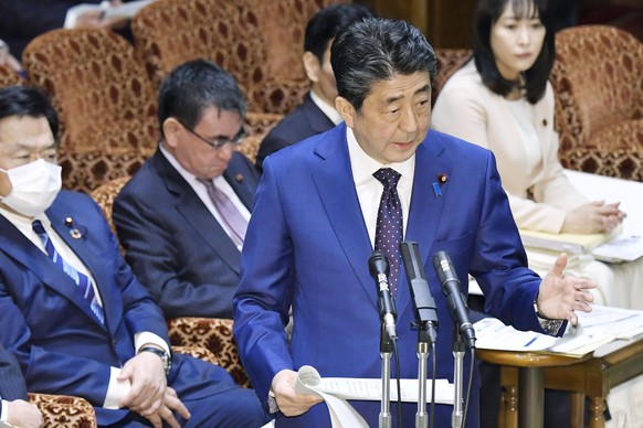 JapanÄôs Prime Minister Shinzo Abe speaks at a parliamentary session in Tokyo Monday, March 23, 2020. Abe said a postponement of Tokyo Olympics would be unavoidable if the games cannot be held in a c ...