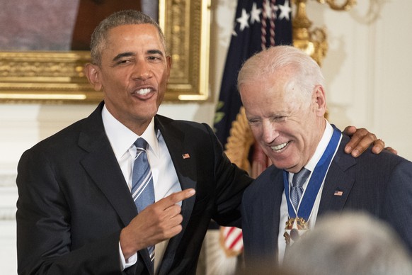epa08362747 (FILE) - US President Barack Obama (L) gestures toward US Vice President Joe Biden (R) after Obama awarded Biden the Presidential Medal of Freedom in the State Dining Room of the White Hou ...