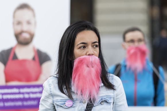 Aktivistinnen der Gewerkschaft UNIA haben sich symbolisch rosa Baerte angeklebt, um ihrer Forderung nach Lohngleichheit zwischen den Geschlechtern Nachdruck zu verleihen, am Rand der Herbstsession der ...