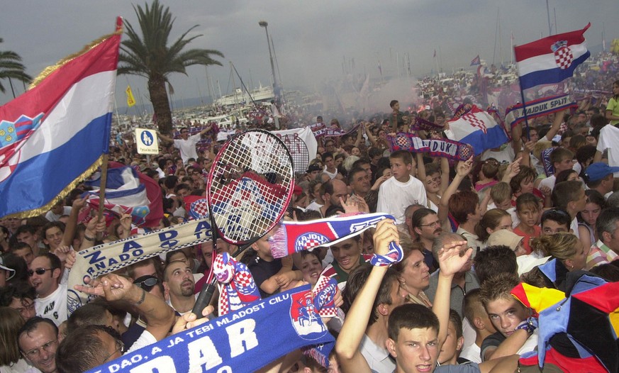 People line the streets of Split, Croatia as they wait for the arrival of Croat tennis player Goran Ivanisevic Tuesday July 10, 2001. Hundreds of thousands of Croats poured into the streets of Ivanise ...