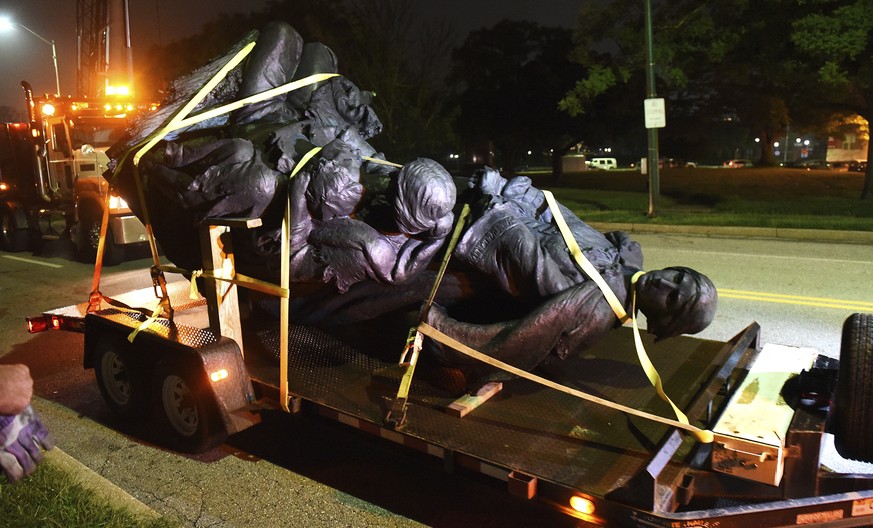 A monument dedicated to the Confederate Women of Maryland lies on a flatbed trailer early Wednesday, Aug. 16, 2017, after it was taken down in Baltimore. Local news outlets reported that workers haule ...