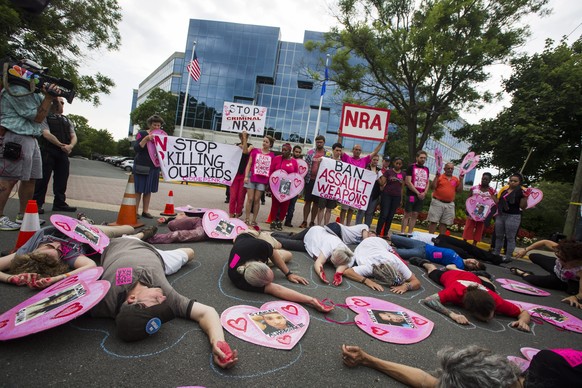 epa05381335 Demonstrators with the activist group CodePink, along with other gun control advocates, hold a &#039;die-in&#039; outside the headquarters of the National Rifle Association (NRA) in Fairfa ...