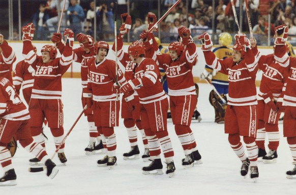 FILE - In this Feb. 26, 1988, file photo, members of the Soviet hockey team skate across the ice with their sticks raised in victory after defeating Sweden to clinch the gold medal at the 1988 Winter  ...