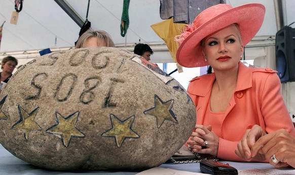 Wife of former Swiss ambassador to Germany, Shawne Fielding Borer, poses next to the legendary Unspunnen stone, in Saigneleger, Switzerland, August 12, 2001. The stone, stolen by separatists of the Ca ...