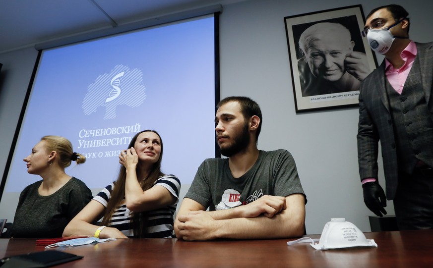 epa08546984 Volunteers on whom the Russian vaccine against COVID-19 was tested on, sit at the table during a news conference at the Science and Practice Center for Interventional Cardioangiology in Mo ...