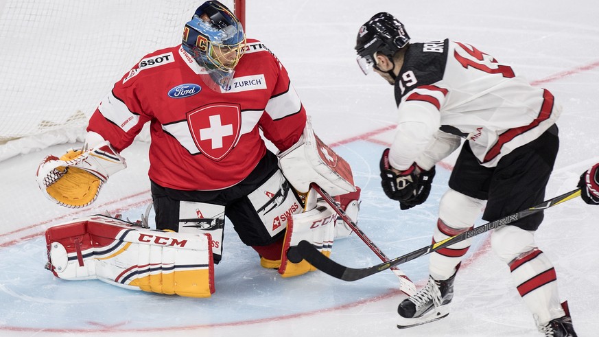 Switzerland’s goaltender Jonas Hiller, left, fights for the puck against Canada&#039;s Gilbert Brule during the 2017 Karjala Cup ice hockey match between Switzerland and Canada in the Tissot Arena in  ...