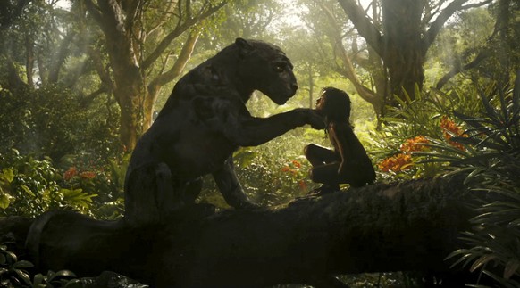 This image released by Netflix shows Rohan Chand as Mowgli, right, and the character Bagheera, voiced by Christian Bale, in a scene from the film, &quot;Mowgli: Legend of the Jungle,&quot; streaming o ...