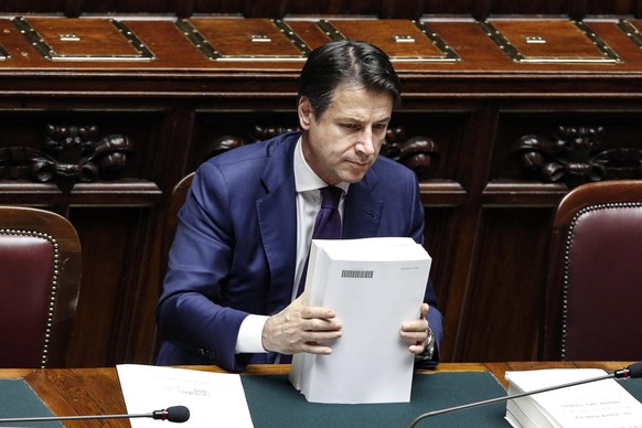 Italian Premier Giuseppe Conte attends a debate prior to a final vote to formally approve the 2019 budget law, at the Italian lower chamber of the Italian Parliament, in Rome, Sunday, Dec. 30, 2018. T ...