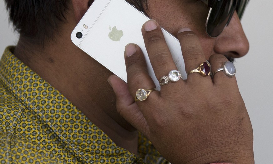 An Indian man talks on his iPhone in New Delhi, India, Wednesday, May 18, 2016. Apple has announced that it will set up an app design and development center in southern India, shortly after company ch ...