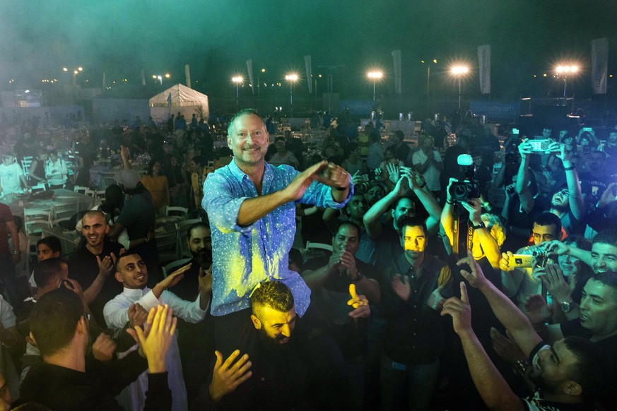 SodaStream CEO Daniel Birnbaum, center, dances with Bedouins, Israelis and Palestinians during a Ramadan fast-ending meal in Rahat, Israel, Monday, May 27, 2019. SodaStream hosted Israelis and Palesti ...
