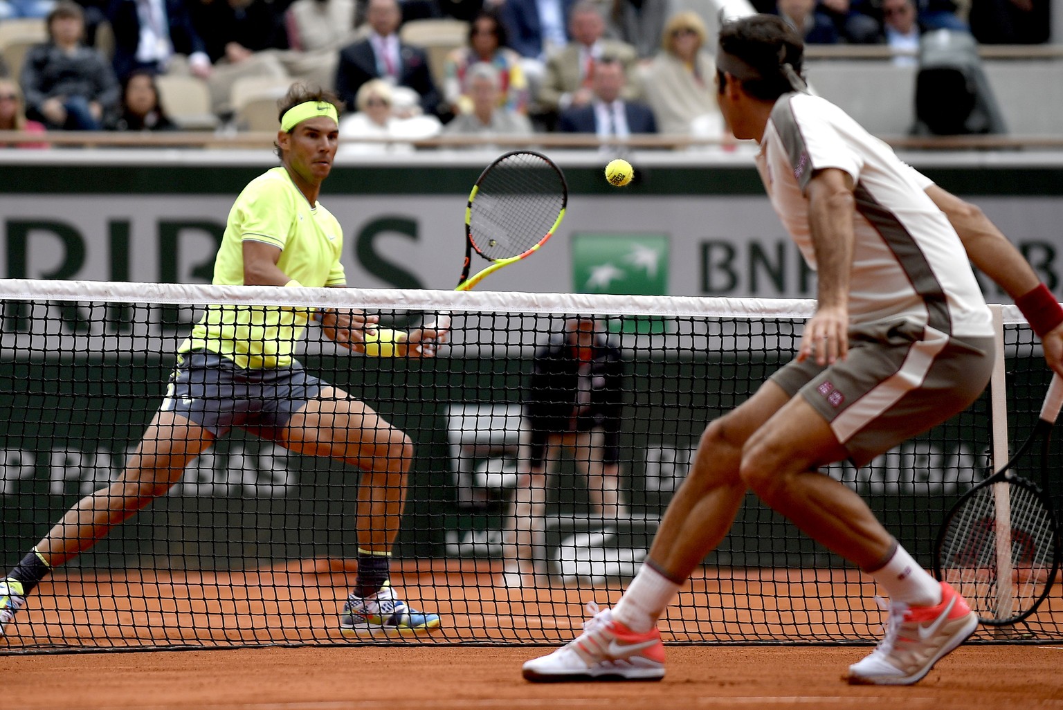 epa07632808 Rafael Nadal of Spain (L) plays Roger Federer of Switzerland during their men’s semi final match during the French Open tennis tournament at Roland Garros in Paris, France, 07 June 2019. E ...