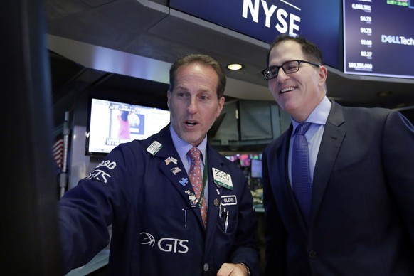 Michael Dell, CEO of Dell Technologies, right, meets with specialist Glenn Carell at the post that trades his company on the floor of the New York Stock Exchange, Monday, July 2, 2018. Dell is going p ...