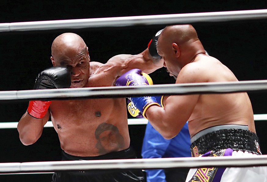 In a photo provided by Triller, Mike Tyson throws a punch during the third round against Roy Jones Jr. in an exhibition boxing bout Saturday, Nov. 28, 2020, in Los Angeles. The bout was unofficially r ...