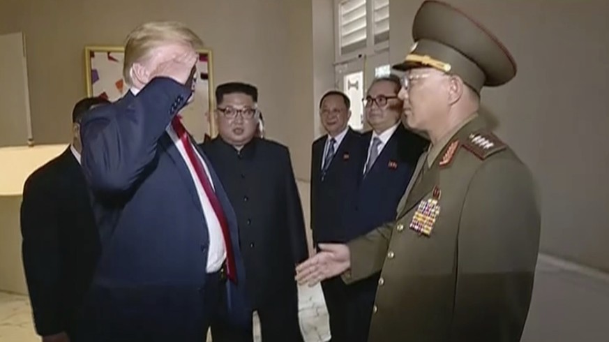 In this image made from June 12, 2018, video released by KRT, U.S. President Donald Trump salutes No Kwang Chol, minister of the People&#039;s Armed Forces of North Korea, as North Korean leader Kim J ...