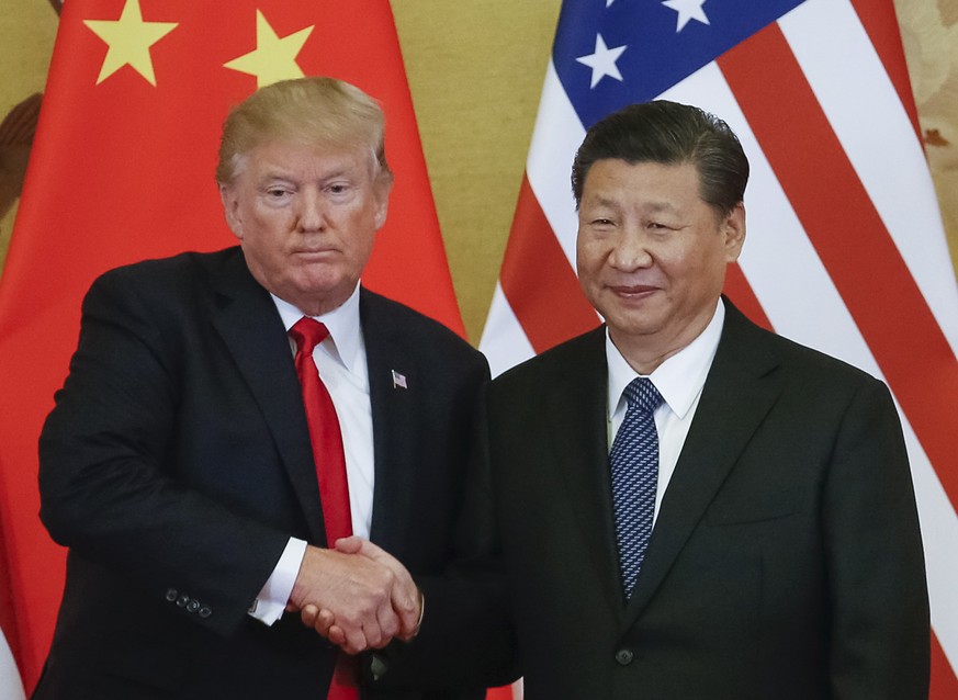 epa07260750 (FILE) - US President Donald J. Trump (L) and Chinese President Xi Jinping (R) shake hands during a press conference at the Great Hall of the People (GHOP) in Beijing, China, 09 November 2 ...