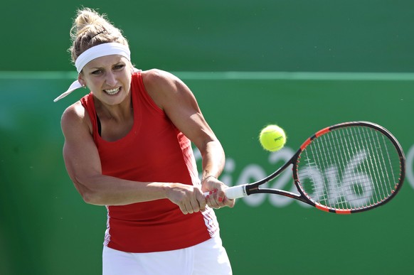 Timea Bacsinszky, of Switzerland, returns to Zhang Shuai, of China, during the 2016 Summer Olympics in Rio de Janeiro, Brazil, Saturday, Aug. 6, 2016. (AP Photo/Charles Krupa)