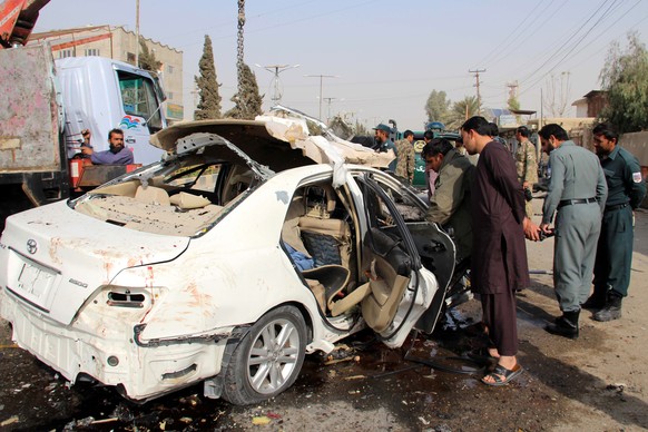 epaselect epa08815025 Afghan security officials inspect the scene of a IED blast in Lashkargah, the provincial capital of Helmand, Afghanistan, 12 November 2020. Police said the explosion targeted a v ...