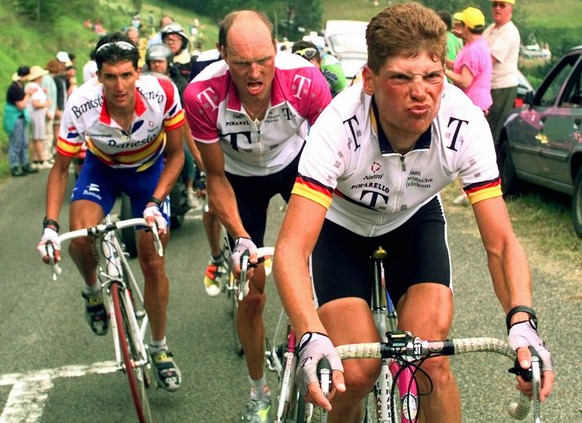 Jan Ullrich of Germany, right, grimaces as he climbs the Val de Louron-Azet pass ahead of his teammate Bjarne Riis of Denmark, center, and Jose-Maria Jimenez of Spain during the 9th stage of the Tour  ...