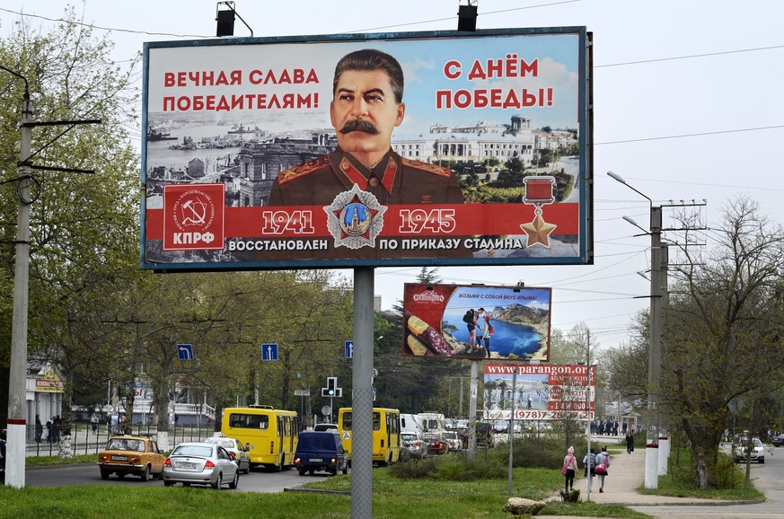 A billboard reading &quot;Eternal glory to the victors&quot; sponsored by the Communist Party, which has always praised Stalin&#039;s role in the defeat of Nazi Germany is seen in a street in Sevastop ...