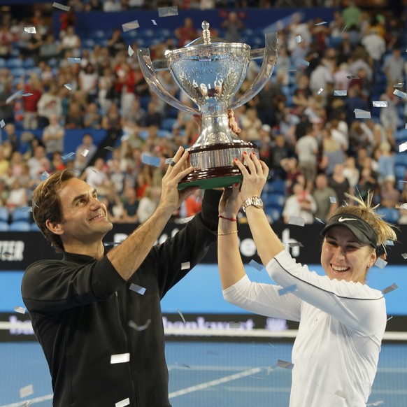 Switzerland&#039;s Roger Federer and Belinda Bencic hold the trophy after winning the final against Alexander Zverev and Angelique Kerber of Germany at the Hopman Cup in Perth, Australia, Saturday Jan ...