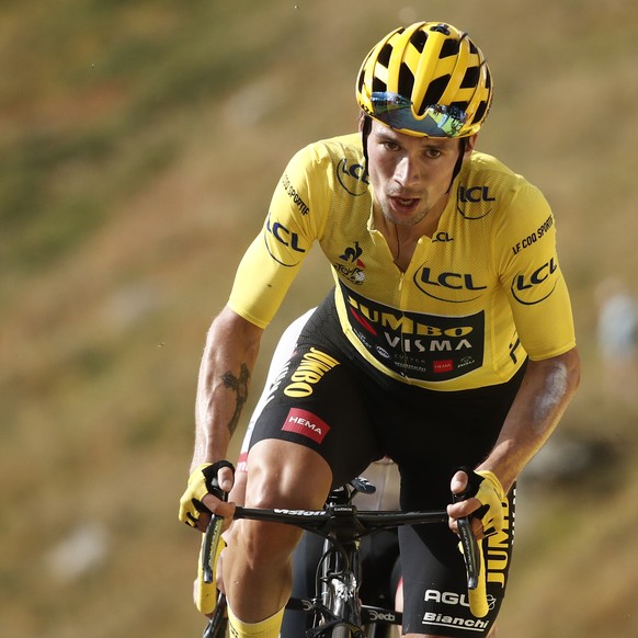 Slovenia&#039;s Primoz Roglic wearing the overall leader&#039;s yellow jersey crosses the finish line of the stage 13 of the Tour de France cycling race over 191 kilometers from Chatel-Guyon to Puy Ma ...