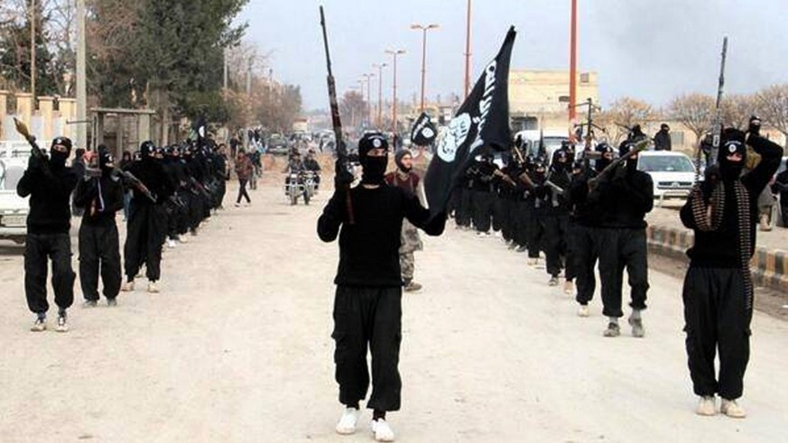 This undated image posted on a militant website on Tuesday, Jan. 14, 2014 shows fighters from the al-Qaida linked Islamic State of Iraq and the Levant (ISIL) marching in Raqqa, Syria. Two weeks of fig ...