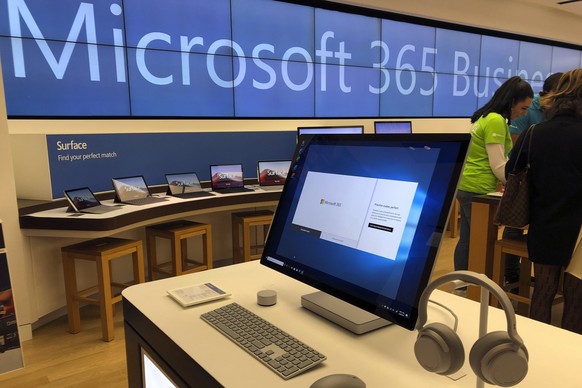 In this Tuesday, Jan. 28, 2020, photo a Microsoft computer is among items displayed at a Microsoft store in suburban Boston. Microsoft reports financial results on Wednesday, Jan. 29, 2020. (AP Photo/ ...