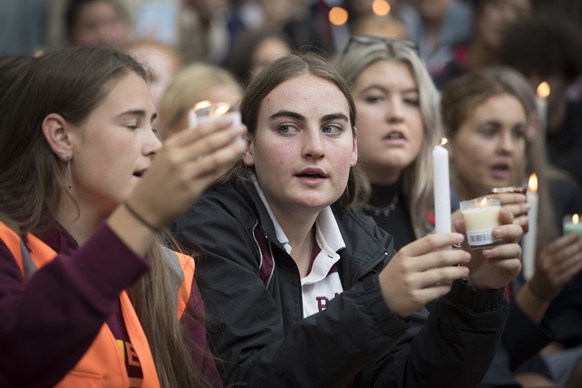 Students hold candles as they gather for a vigil to commemorate victims of Friday&#039;s shooting, outside the Al Noor mosque in Christchurch, New Zealand, Monday, March 18, 2019. Three days after Fri ...
