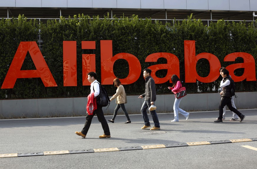 epa08979739 (FILE) - People walk past a sign at the headquarter campus of Alibaba Group in Hangzhou, Zhejiang province, China, 17 March 2014 (reissued 01 January 2021). Alibaba is due to publish their ...