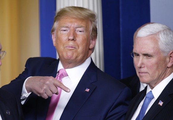 epa08251090 US President Donald J. Trump (L) gestures as he and US Vice President Mike Pence depart after speaking to the media in the James S. Brady Briefing room with members of the Coronavirus Task ...