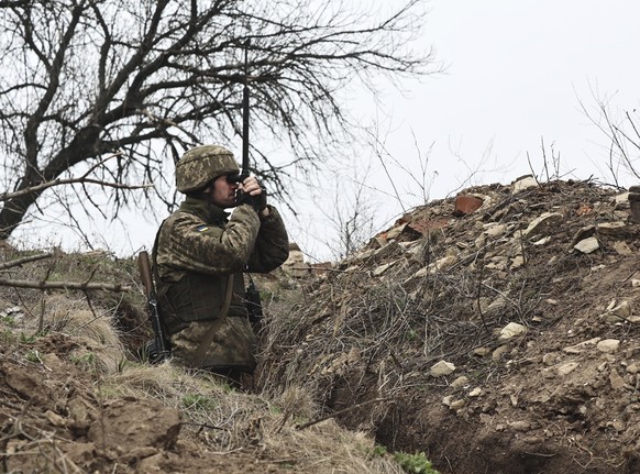 A Ukrainian soldier is seen at fighting positions on the line of separation from pro-Russian rebels near Donetsk, Ukraine, Monday, April 12, 2021. Ukraine&#039;s President Volodymyr Zelenskyy has requ ...