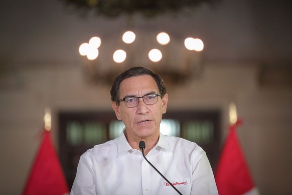 epa08669276 A handout photo made available by the Presidency of Peru shows President Martin Vizcarra during a message to the Nation, at the Government Palace in Lima, Peru, 14 September 2020. Vizcarra ...