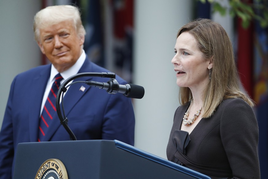 epa08700062 Judge Amy Coney Barrett (R) speaks after being introduced by US President Donald J. Trump as his nominee to be an Associate Justice of the Supreme Court during a ceremony in the Rose Garde ...