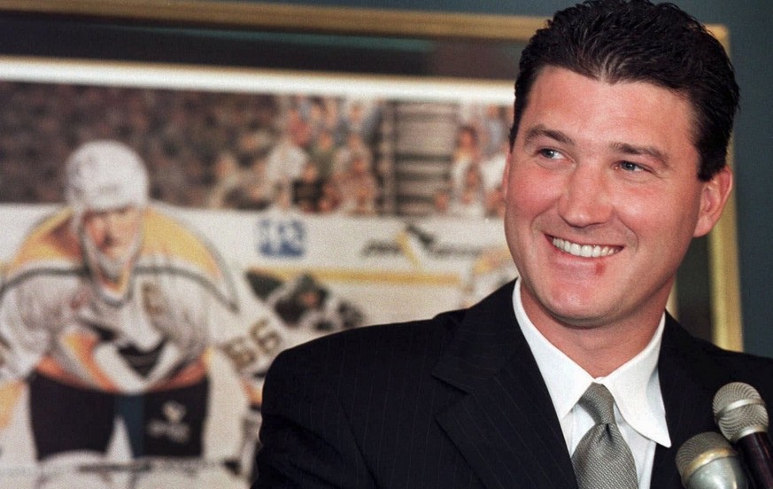 With a print of himself as a player in the backround, Pittsburgh Penguins new owner Mario Lemieux responds to a question during a news conference in Pittsburgh, in this September 3, 1999 photo. Lemieu ...