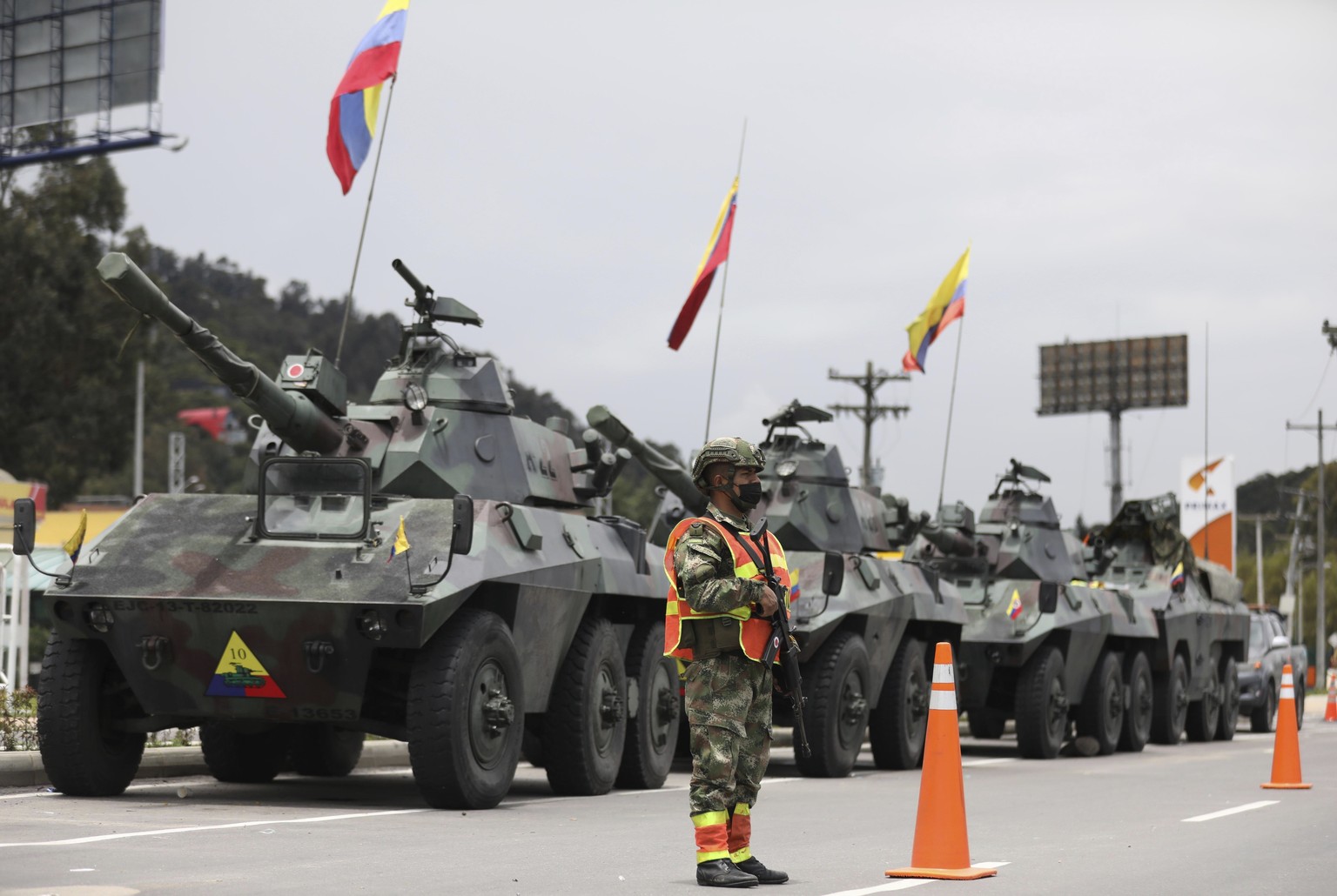 Soldiers and army tanks guard toll booths to keep protesters from damaging them, on the outskirts of Bogota, Colombia, Tuesday, May 4, 2021. Colombia���s finance minister resigned on Monday following  ...