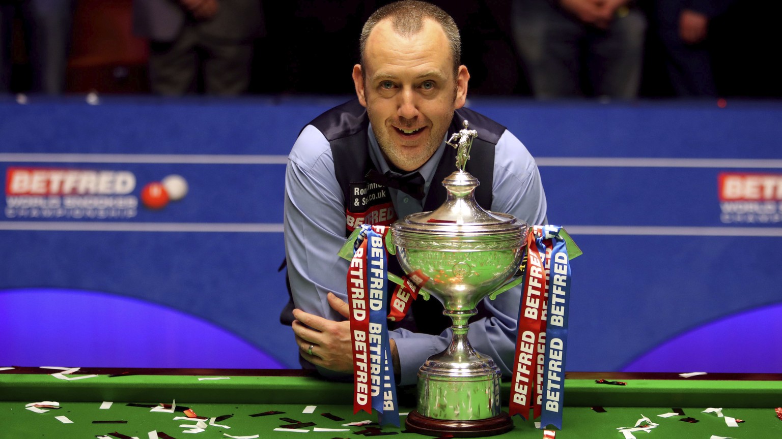 Britain&#039;s Mark Williams poses with the trophy after winning the 2018 Snooker World Championship at The Crucible, Sheffield, England, Monday, May 7, 2018. Mark Williams has won the world snooker c ...