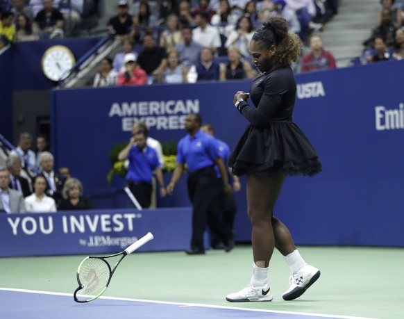 Serena Williams slams her racket on the court during the women&#039;s final of the U.S. Open tennis tournament against Naomi Osaka, of Japan, Saturday, Sept. 8, 2018, in New York. (AP Photo/Julio Cort ...