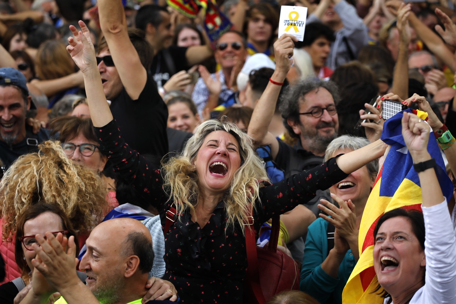 Maria Salut, 50, center, reacts as they celebrate the unilateral declaration of independence of Catalonia outside the Catalan Parliament, in Barcelona, Spain, Friday, Oct. 27, 2017. Catalonias&#039; r ...