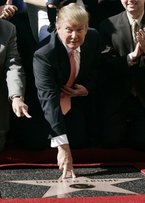 FILE - In this Jan. 16, 2007, file photo, Donald Trump, center, the billionaire and developer and producer of NBC&#039;s &quot;The Apprentice,&quot; is honored with a star on the Hollywood Walk of Fam ...