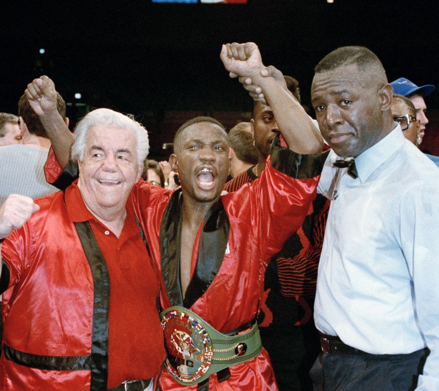 FILE - In this March 6, 1993, file photo, Pernell Whitaker celebrates after winning his third world championship with a unanimous decision over James &quot;Buddy&quot; McGirt in a 12-round bout at New ...
