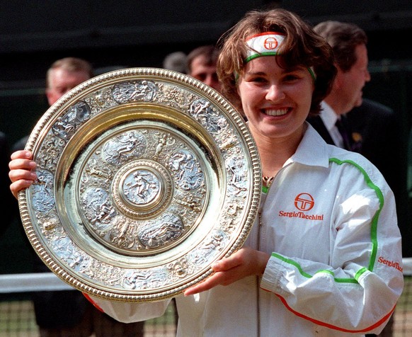 Martina Hingis holds her trophy, after defeating Jana Novotna in the Women&#039;s Singles final on the Centre Court at Wimbledon, July 5, 1997. Hingis won the final 2-6, 6-3, 6-3, to become the younge ...