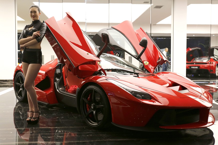 epa05654660 (FILE) A file picture dated 30 April 2015 shows a model posing beside a Ferrari LaFerrari hybrid sports car at a Dream Car Show in Beijing city, China. According to media reports on 01 Dec ...