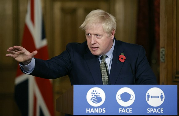 Britain&#039;s Prime Minister Boris Johnson reaches out during a virtual press conference on the coronavirus pandemic at 10 Downing Street in central London Monday Nov. 9, 2020. Johnson gave some deta ...